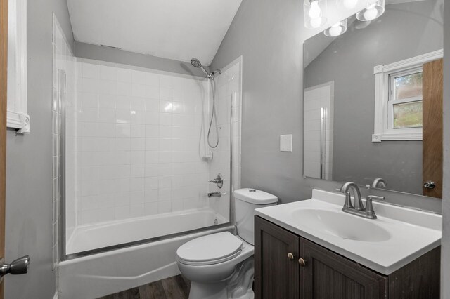 414 Western Ln, Anoka, MN 55303 - full bath with shower / bathtub combination, vanity, toilet, wood finished floors, and lofted ceiling