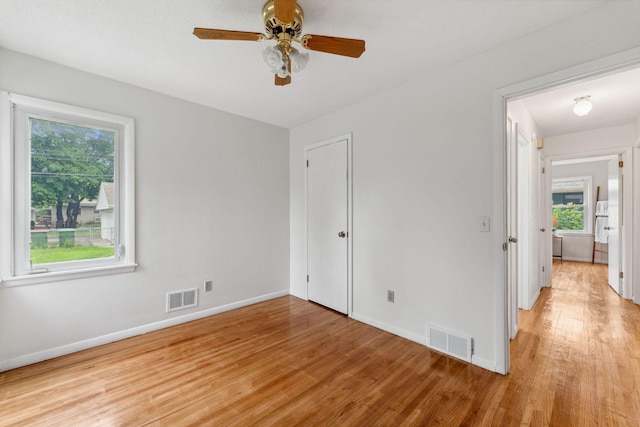 225 7th Ave NE, Osseo, MN 55369 - spare room featuring light wood-type flooring, healthy amount of natural light, and baseboards