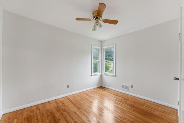 225 7th Ave NE, Osseo, MN 55369 - empty room with light wood-style flooring, baseboards, and ceiling fan
