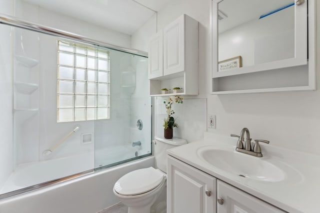 225 7th Ave NE, Osseo, MN 55369 - bathroom featuring toilet, vanity, and enclosed tub / shower combo