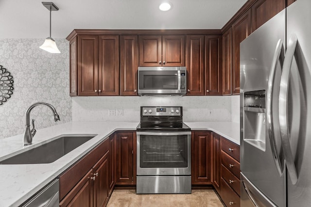 7582 Ojibway Park Bay, Woodbury, MN 55125 - kitchen featuring stainless steel appliances, hanging light fixtures, light stone counters, and tasteful backsplash