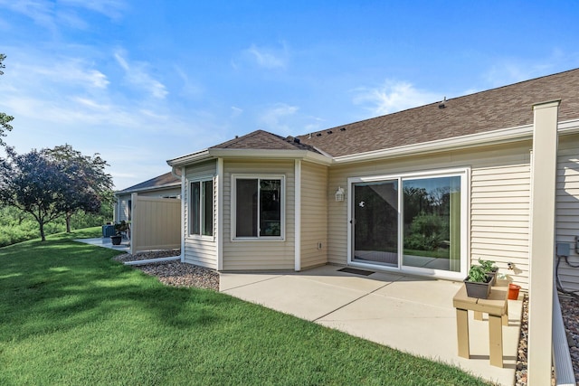 7582 Ojibway Park Bay, Woodbury, MN 55125 - rear view of house with a patio area, a lawn, and a shingled roof