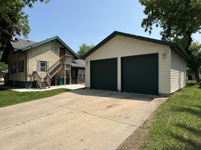 1315 Clark St W, Albert Lea, MN 56007 - view of front facade with a garage, an outdoor structure, and stucco siding