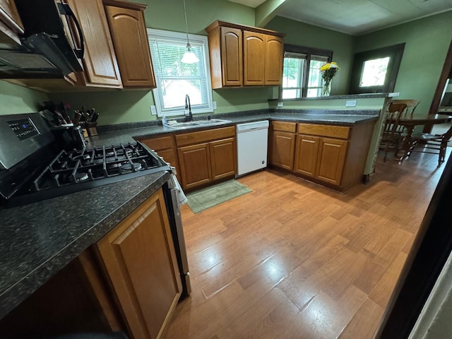1315 Clark St W, Albert Lea, MN 56007 - kitchen with black appliances, a sink, light wood-style floors, and a peninsula