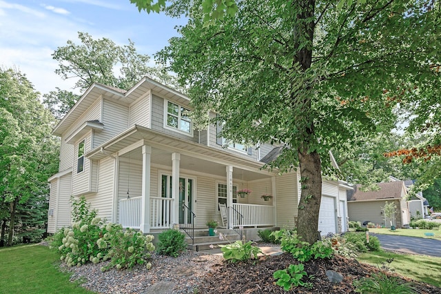 10426 Hidden Oaks Ln N, Champlin, MN 55316 - view of front of home featuring a porch, an attached garage, and driveway