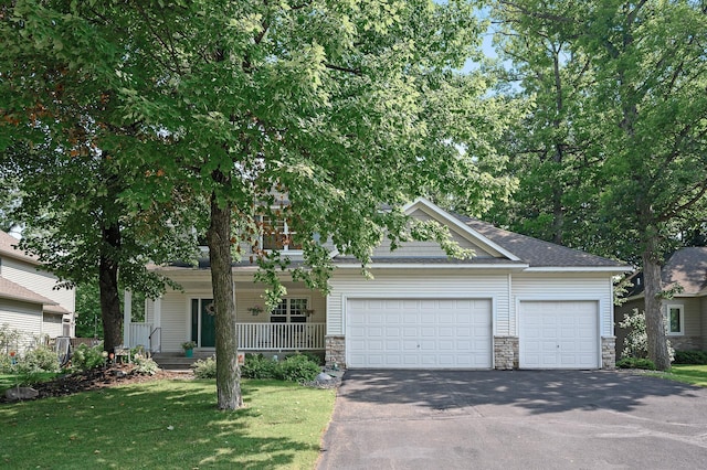 10426 Hidden Oaks Ln N, Champlin, MN 55316 - view of front facade featuring driveway, an attached garage, stone siding, and a front lawn