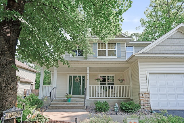 10426 Hidden Oaks Ln N, Champlin, MN 55316 - view of front of property featuring covered porch and an attached garage