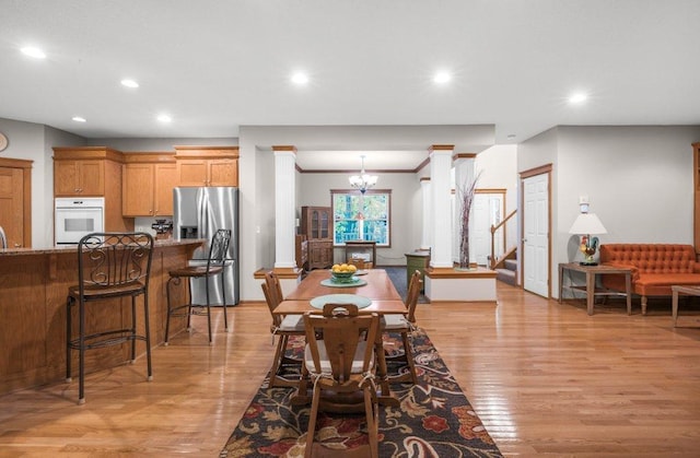 10426 Hidden Oaks Ln N, Champlin, MN 55316 - dining space with a chandelier, light wood-type flooring, recessed lighting, stairway, and crown molding