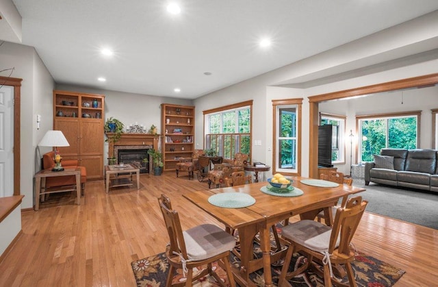 10426 Hidden Oaks Ln N, Champlin, MN 55316 - dining area featuring recessed lighting, a glass covered fireplace, and light wood-type flooring