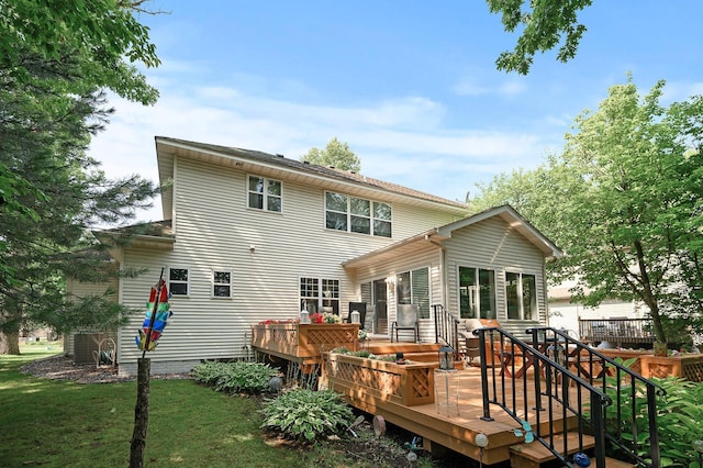 10426 Hidden Oaks Ln N, Champlin, MN 55316 - back of house with a deck and a lawn