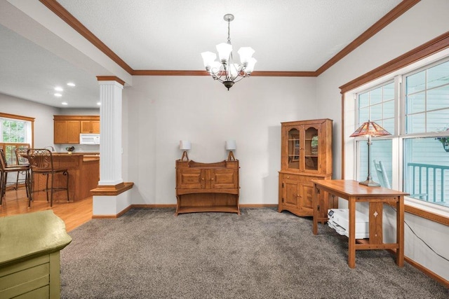 10426 Hidden Oaks Ln N, Champlin, MN 55316 - sitting room with decorative columns, a chandelier, carpet flooring, and crown molding