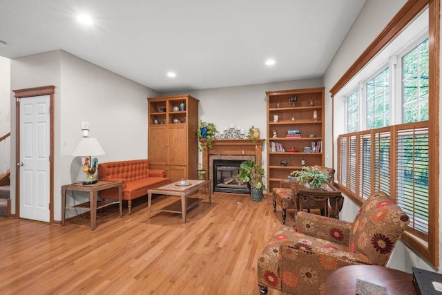 10426 Hidden Oaks Ln N, Champlin, MN 55316 - living area with light wood-style floors, recessed lighting, a glass covered fireplace, and stairs