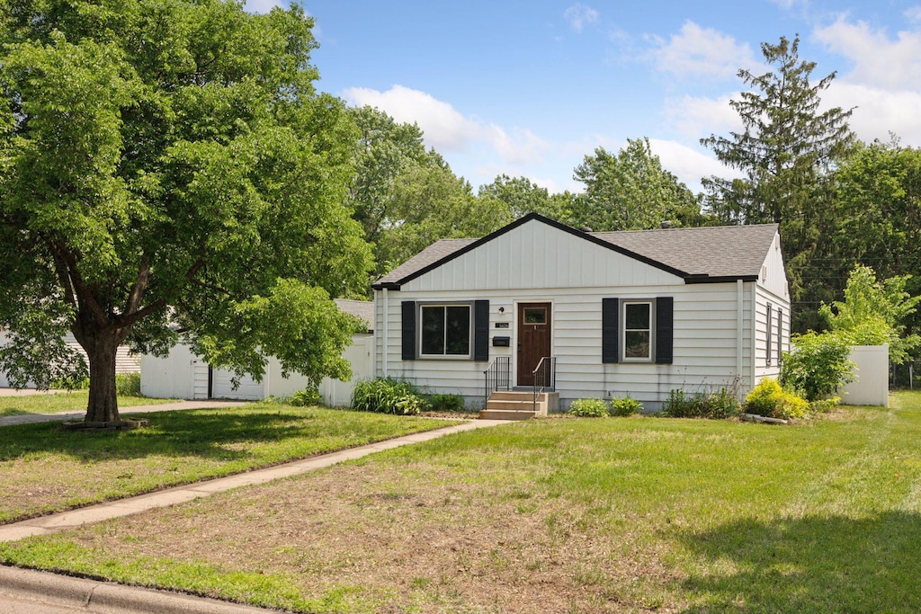 5626 Knox Ave N, Brooklyn Center, MN 55430 - view of front of home featuring a shingled roof and a front lawn
