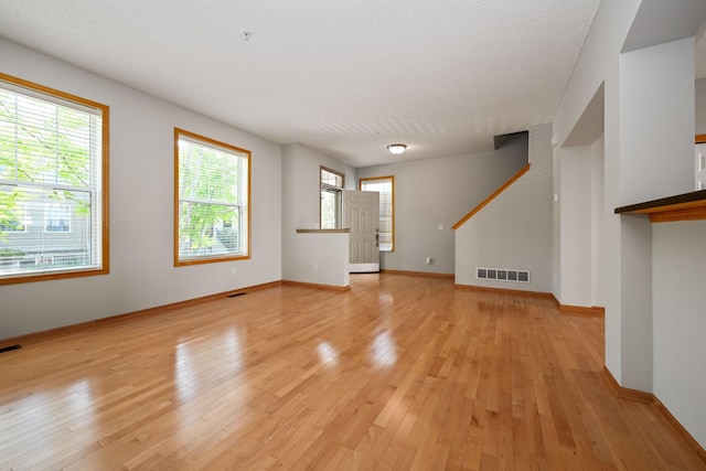 8280 Labont Way, Eden Prairie, MN 55344 - unfurnished living room with light wood-type flooring, stairs, and baseboards