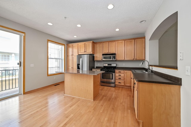 8280 Labont Way, Eden Prairie, MN 55344 - kitchen featuring stainless steel appliances, a sink, a kitchen island, recessed lighting, and light wood-style floors