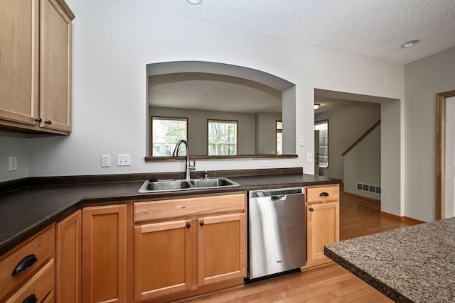 8280 Labont Way, Eden Prairie, MN 55344 - kitchen featuring stainless steel dishwasher, a sink, light wood-style floors, dark countertops, and a textured ceiling