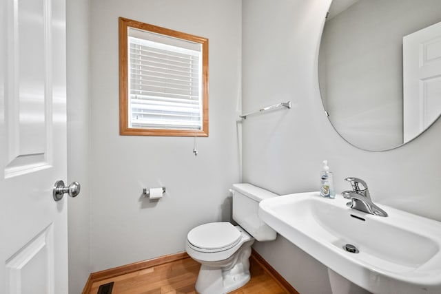 8280 Labont Way, Eden Prairie, MN 55344 - half bath with a sink, wood finished floors, toilet, and baseboards