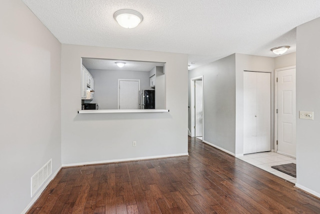 2040 Shenandoah Ct Unit B, Plymouth, MN 55447 - unfurnished room featuring wood-type flooring and a textured ceiling