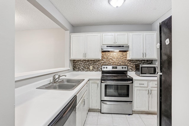 2040 Shenandoah Ct Unit B, Plymouth, MN 55447 - kitchen with stainless steel appliances, under cabinet range hood, a textured ceiling, light countertops, and light tile patterned floors
