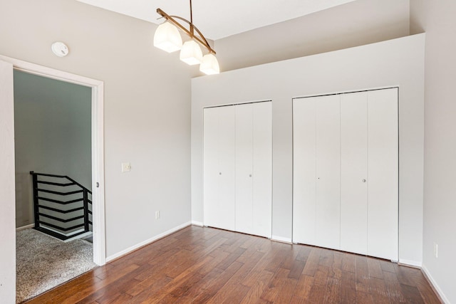 2040 Shenandoah Ct Unit B, Plymouth, MN 55447 - unfurnished bedroom featuring multiple closets and wood finished floors