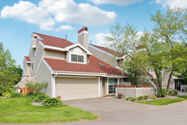 2040 Shenandoah Ct Unit B, Plymouth, MN 55447 - traditional-style house with asphalt driveway, roof with shingles, a chimney, a front yard, and an attached garage