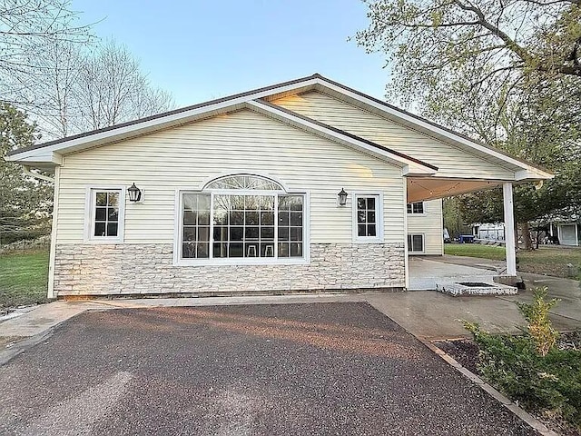 2120 Walden Blvd NW, Oak Grove, MN 55011 - view of home's exterior with stone siding and a patio
