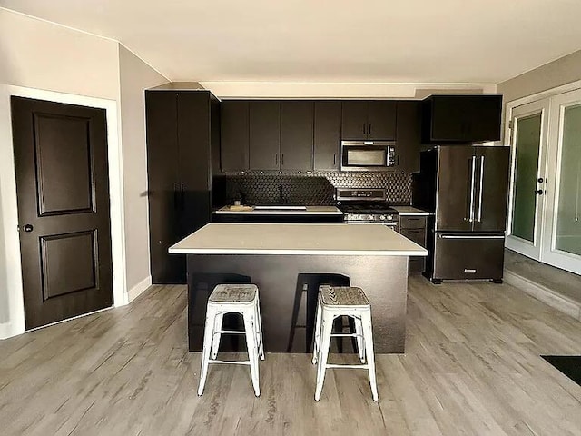 2120 Walden Blvd NW, Oak Grove, MN 55011 - kitchen featuring stainless steel appliances, light countertops, a kitchen island, and light wood finished floors