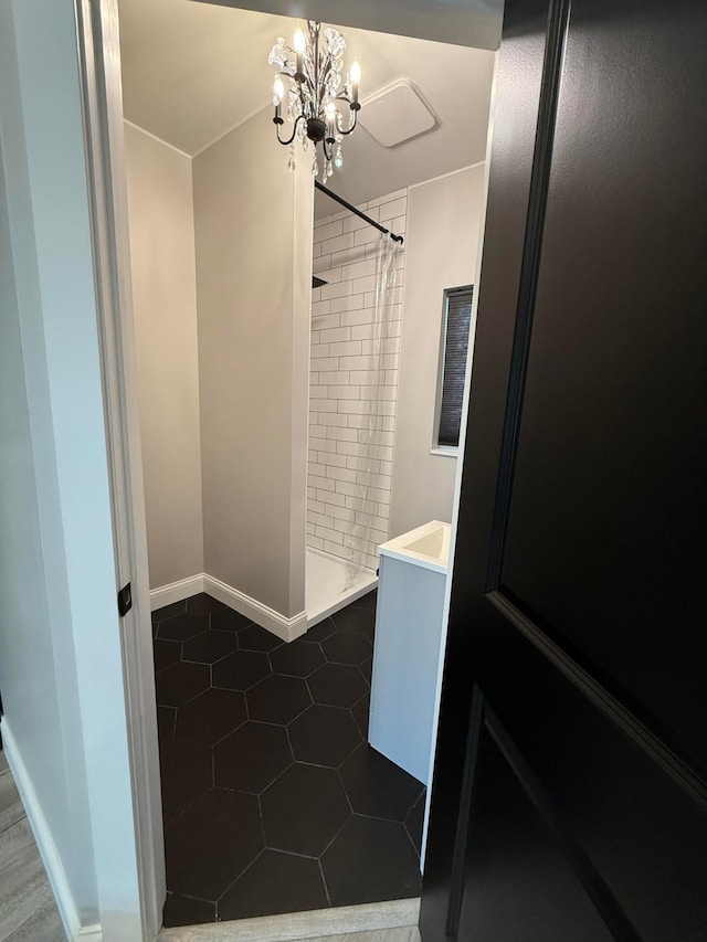 2120 Walden Blvd NW, Oak Grove, MN 55011 - bathroom featuring vanity, tiled shower, a chandelier, and tile patterned flooring