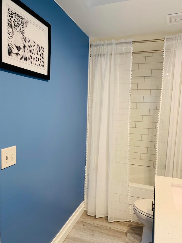 2120 Walden Blvd NW, Oak Grove, MN 55011 - bathroom featuring wood finished floors, vanity, and shower / bath combination with curtain