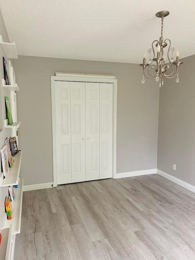 2120 Walden Blvd NW, Oak Grove, MN 55011 - recreation room with a textured ceiling, light wood-style flooring, and a chandelier