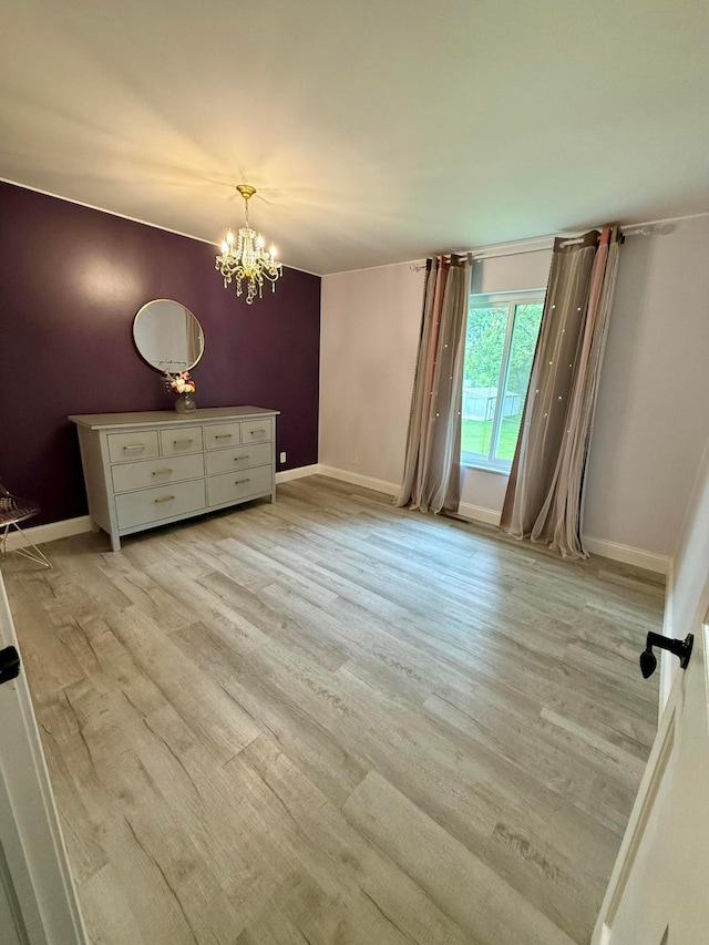 2120 Walden Blvd NW, Oak Grove, MN 55011 - spare room featuring a chandelier and light wood-type flooring