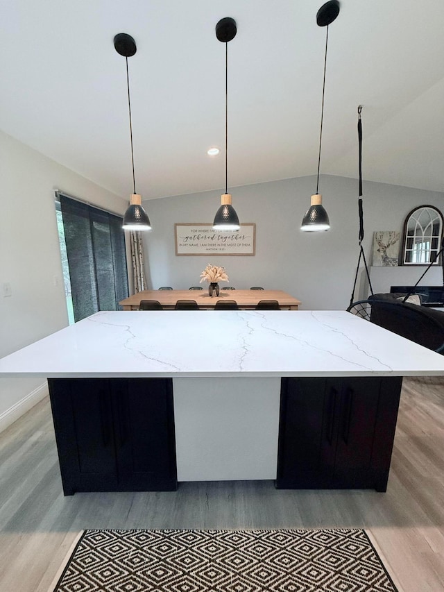 2120 Walden Blvd NW, Oak Grove, MN 55011 - kitchen featuring light wood-style floors, hanging light fixtures, a kitchen island, and lofted ceiling
