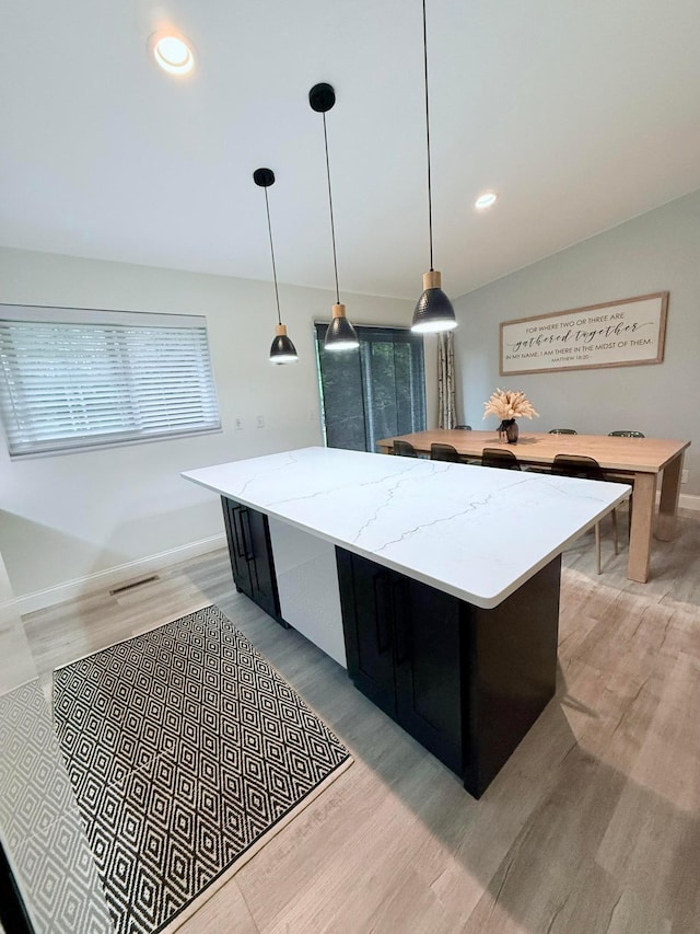 2120 Walden Blvd NW, Oak Grove, MN 55011 - kitchen with light wood-style flooring, a center island, hanging light fixtures, dark cabinets, and recessed lighting