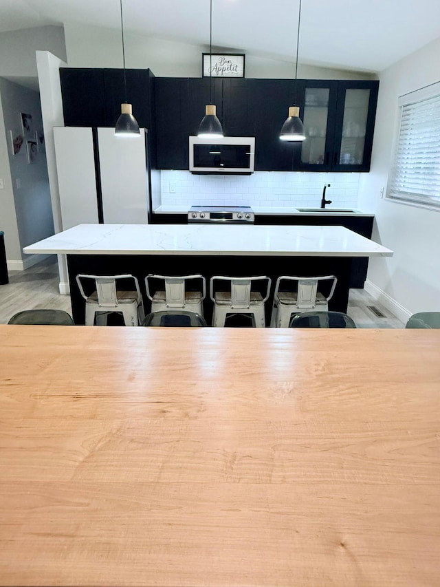 2120 Walden Blvd NW, Oak Grove, MN 55011 - dining space featuring vaulted ceiling and light wood-style flooring