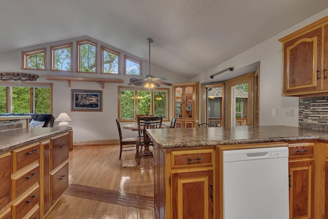 14789 Fireside Cir, Cold Spring, MN 56320 - kitchen featuring dishwasher, a peninsula, ceiling fan, lofted ceiling, and light wood-style flooring