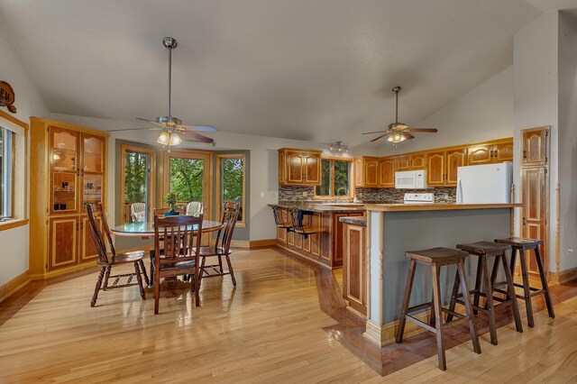 14789 Fireside Cir, Cold Spring, MN 56320 - dining area featuring ceiling fan, lofted ceiling, and light wood-style flooring