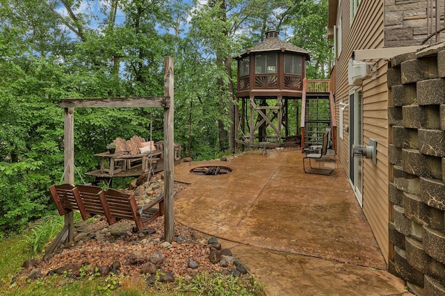 14789 Fireside Cir, Cold Spring, MN 56320 - view of patio with a fire pit and view of scattered trees