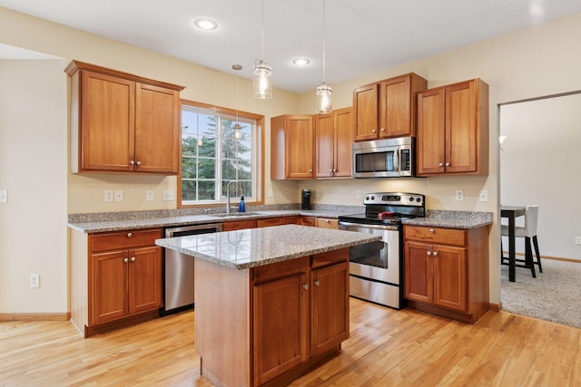 2097 138th St W, Rosemount, MN 55068 - kitchen featuring stainless steel appliances, a kitchen island, light wood finished floors, brown cabinetry, and recessed lighting
