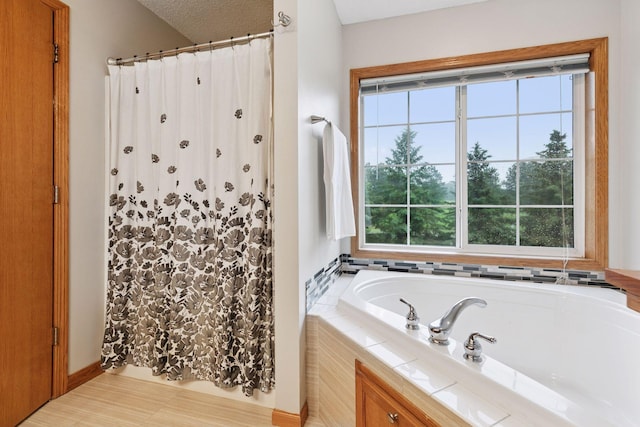 2097 138th St W, Rosemount, MN 55068 - full bathroom with a garden tub, a shower with curtain, and a textured ceiling