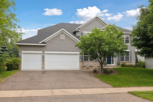 2097 138th St W, Rosemount, MN 55068 - view of front facade with asphalt driveway, an attached garage, a front yard, roof with shingles, and brick siding