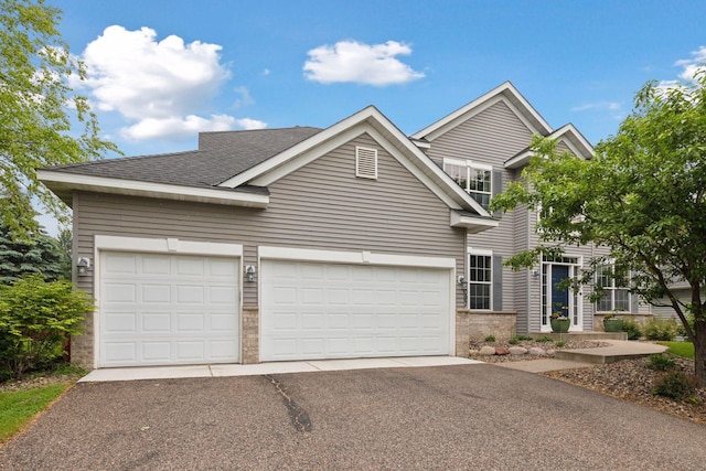 2097 138th St W, Rosemount, MN 55068 - view of front of property with asphalt driveway, a garage, brick siding, and a shingled roof