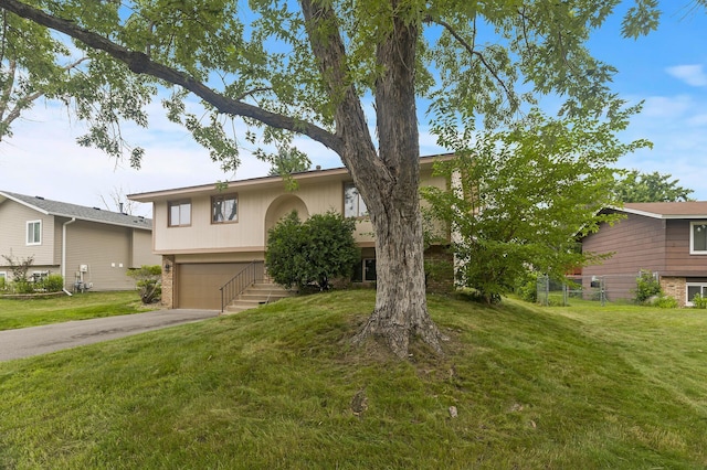 6716 83rd Ave N, Brooklyn Park, MN 55445 - view of front facade with driveway, a garage, and a front yard