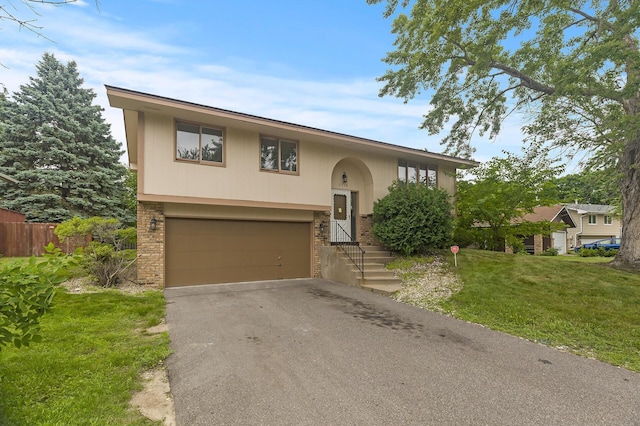 6716 83rd Ave N, Brooklyn Park, MN 55445 - split foyer home with brick siding, a garage, and driveway