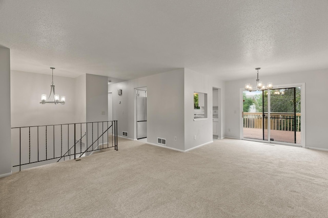 6716 83rd Ave N, Brooklyn Park, MN 55445 - carpeted spare room with a chandelier and a textured ceiling