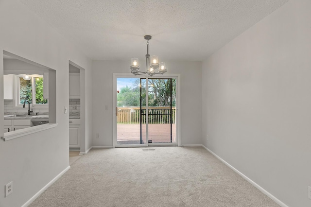 6716 83rd Ave N, Brooklyn Park, MN 55445 - spare room with a chandelier, light colored carpet, and a textured ceiling
