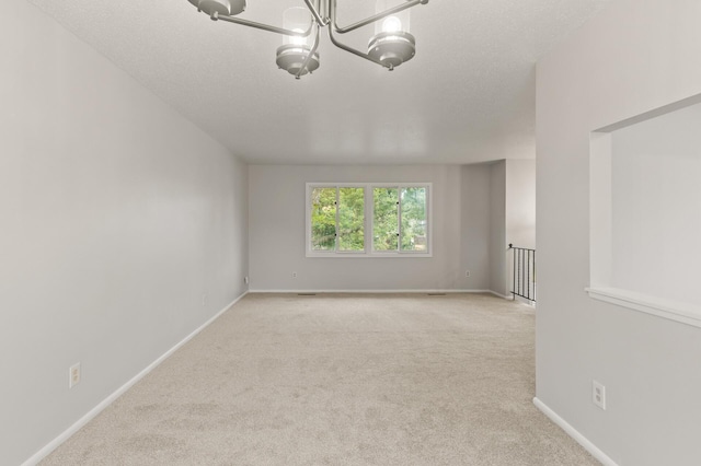6716 83rd Ave N, Brooklyn Park, MN 55445 - empty room with carpet flooring and a chandelier