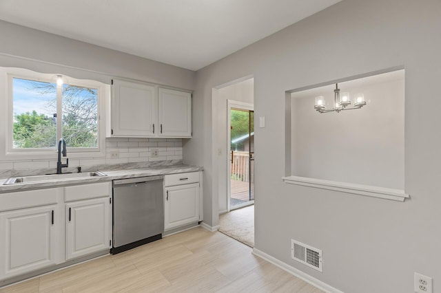 6716 83rd Ave N, Brooklyn Park, MN 55445 - kitchen with dishwasher, a chandelier, white cabinetry, light countertops, and plenty of natural light
