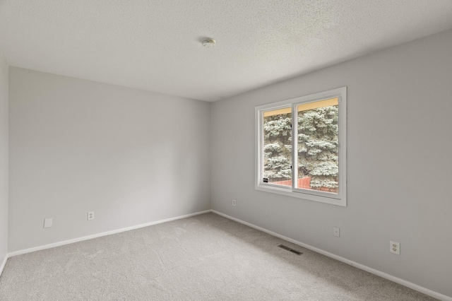 6716 83rd Ave N, Brooklyn Park, MN 55445 - empty room featuring a smoke detector, carpet floors, and a textured ceiling