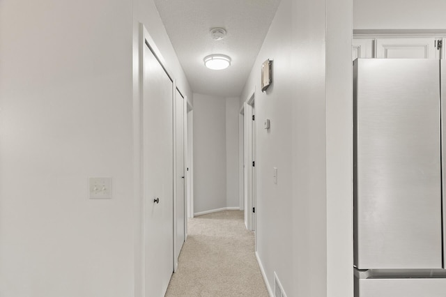 6716 83rd Ave N, Brooklyn Park, MN 55445 - hall featuring light colored carpet and a textured ceiling