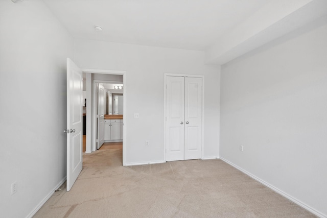 13560 Technology Dr Unit 1102, Eden Prairie, MN 55344 - unfurnished bedroom featuring light colored carpet, baseboards, and a closet
